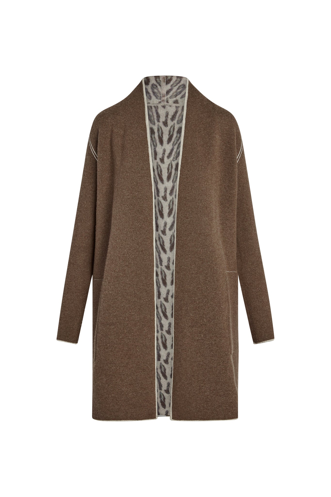Catherine Gee Double Face Cashmere Reversible New Leopard Coat. This luxurious coat features a rich brown exterior with a subtle texture and a contrasting inner lining with a bold leopard print. The coat has a long, open-front design with long sleeves and minimalistic seams, offering a sophisticated and versatile look that can be worn inside out for a different style.
