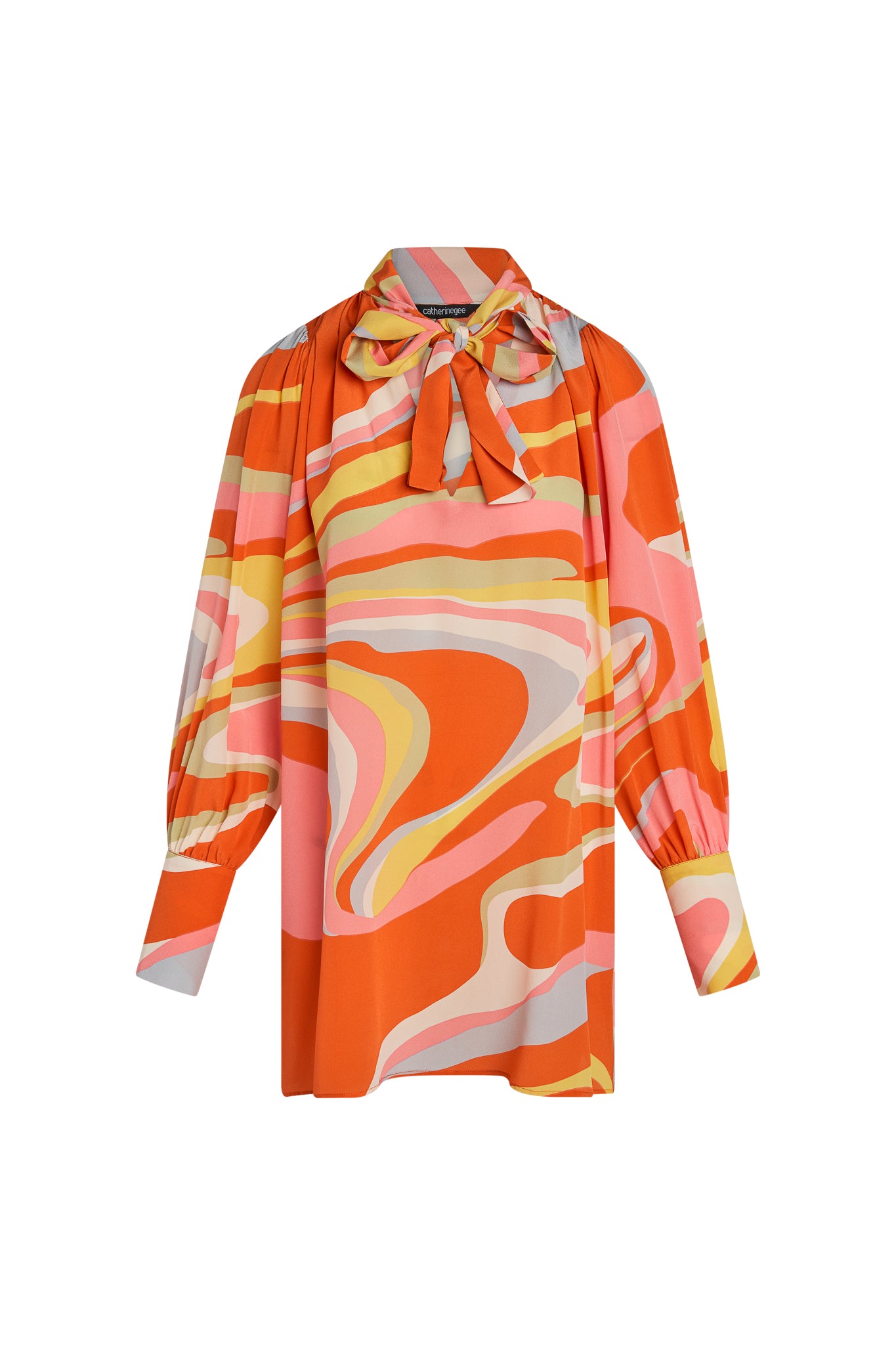 A vibrant Catherine Gee Aussie Short Dress - Sherbet features a bold, abstract pattern with swirling shades of orange, pink, yellow, and white. It has long sleeves with gathered cuffs and a tie-neck detail at the collar.