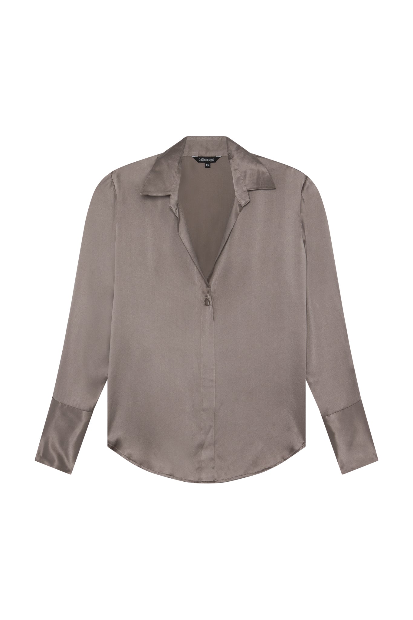 Catherine Gee Daria French Cuff Silk-Grey blouse is made of silk and features a sleek, smooth texture. It has a grey color, long sleeves with French cuffs, a collar, and a front zipper closure. The design is elegant and sophisticated, making it a versatile piece for various occasions.