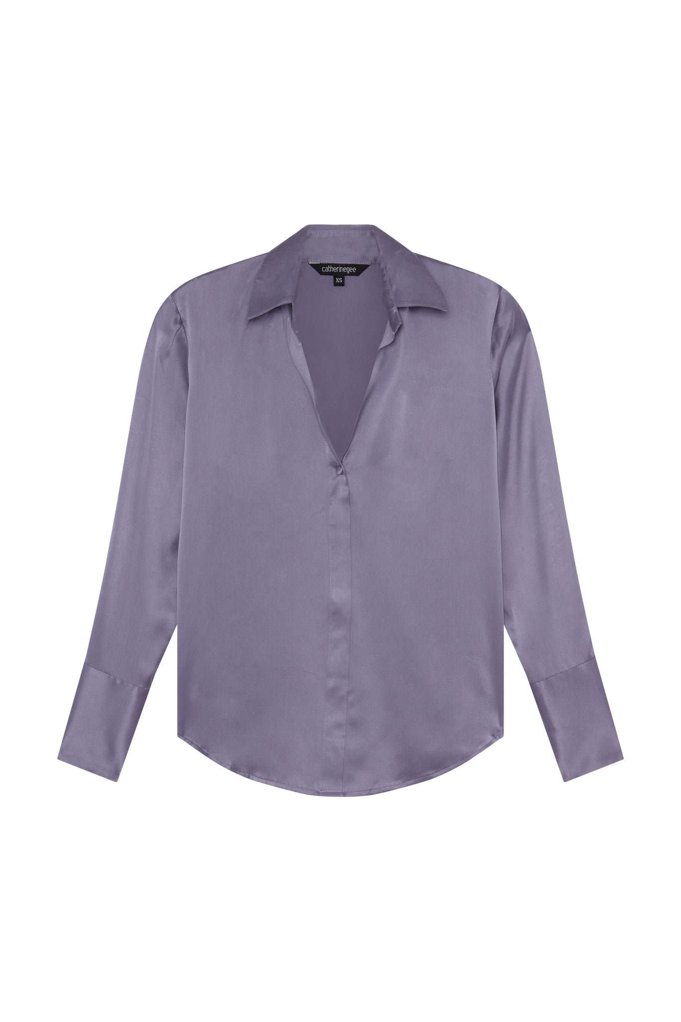 Catherine Gee Daria French Cuff Silk Blouse Lavender. The blouse features a deep V-neckline, long sleeves with French cuffs, and a smooth, silky texture with a soft color lavender, giving it a sophisticated and elegant appearance.