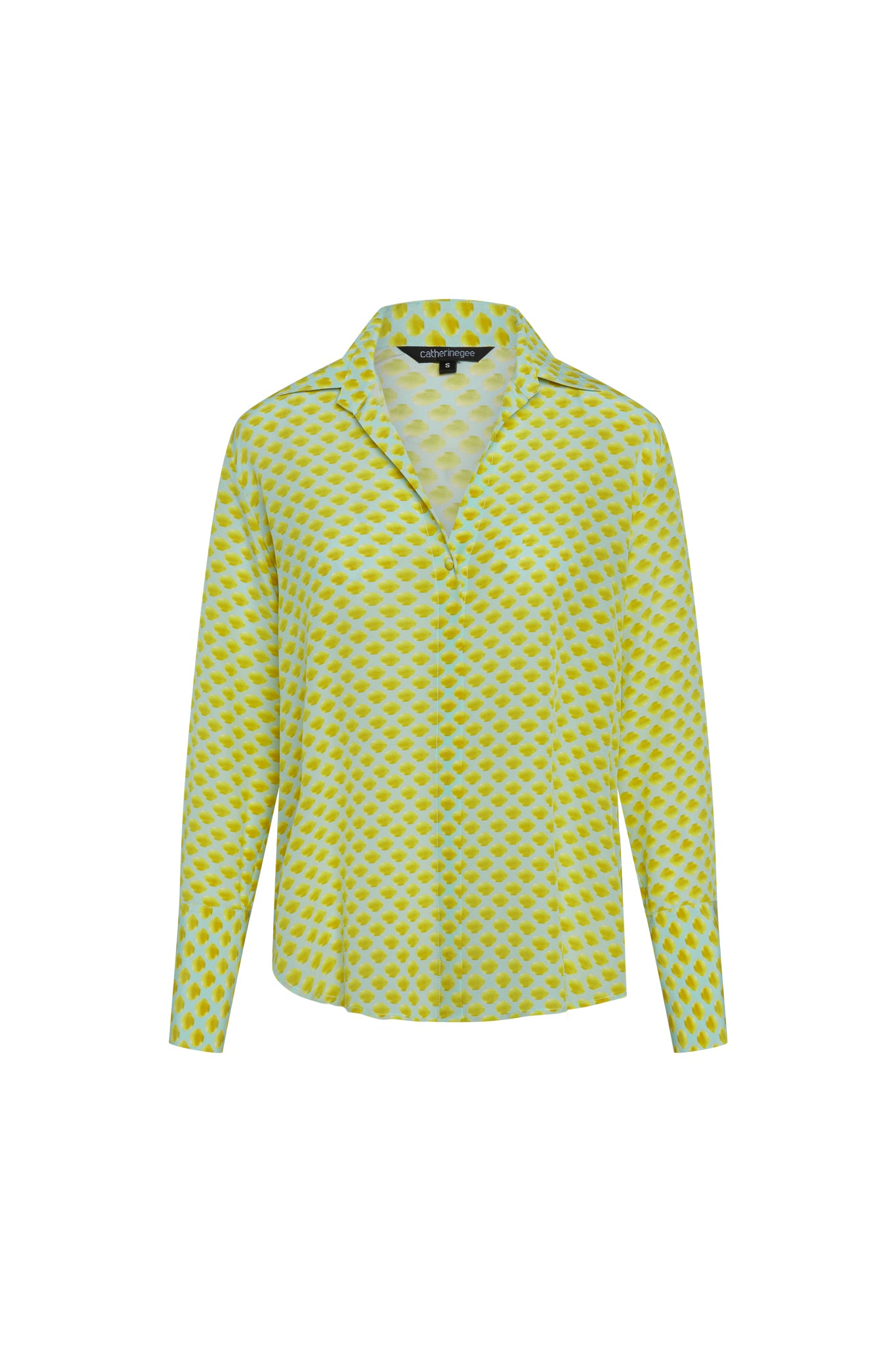 A Catherine Gee Daria French Cuff Silk-Limon Blue (Mini) blouse features a light background with a pattern of vibrant yellow mini lemon-like spots, with a collared neckline and long sleeves. The fabric appears lightweight and silky, providing a stylish and comfortable fit.