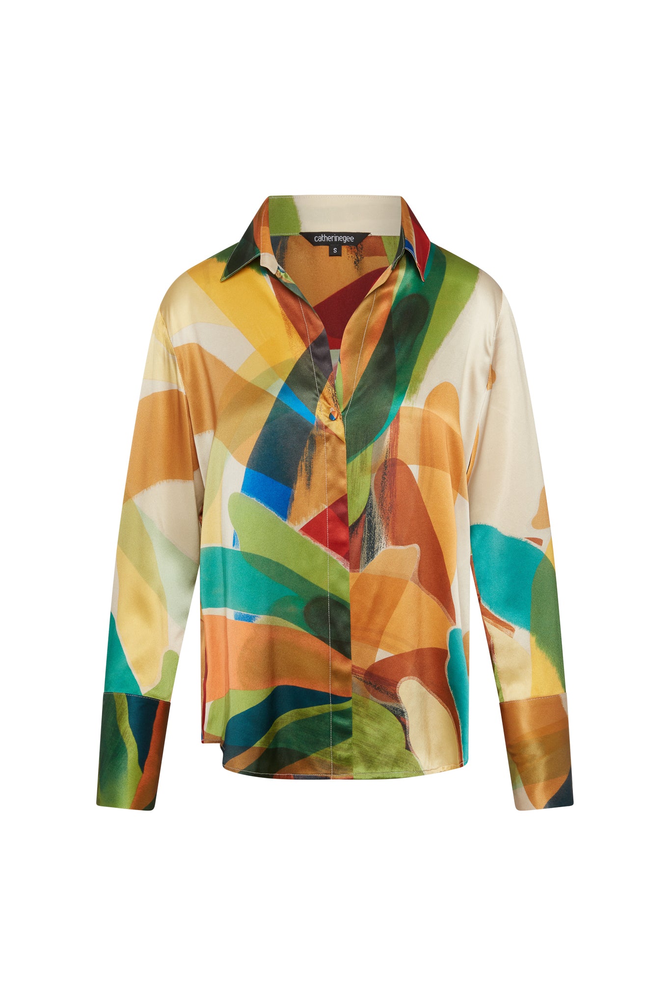 Catherine Gee Daria French Cuff Silk Stella Print blouse features a vibrant and abstract print with a mix of colors including green, blue, orange, yellow, and brown. It has a classic collar, button-down front, and long sleeves with French cuffs. The silk material gives it a luxurious and smooth appearance, making it a stylish and elegant piece suitable for various occasions.