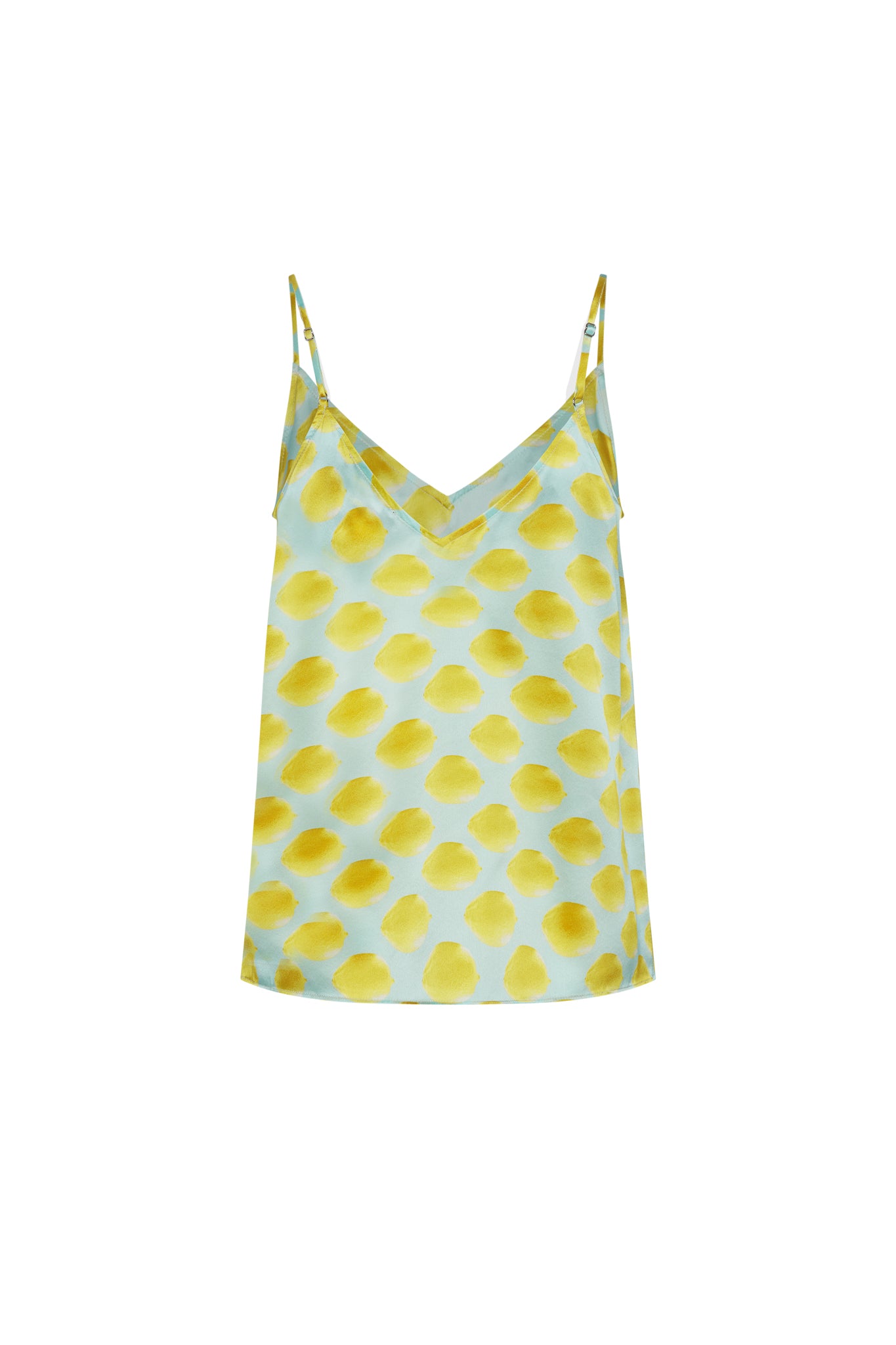 Catherine Gee Franka Cami - Limon Blue. This stylish cami features a light blue base with a pattern of yellow lemon-like spots. The top has a V-neckline and thin adjustable straps, making it a versatile piece for various occasions. The bright and playful design adds a touch of freshness and vibrancy, making it an eye-catching and fashionable choice for warm weather.