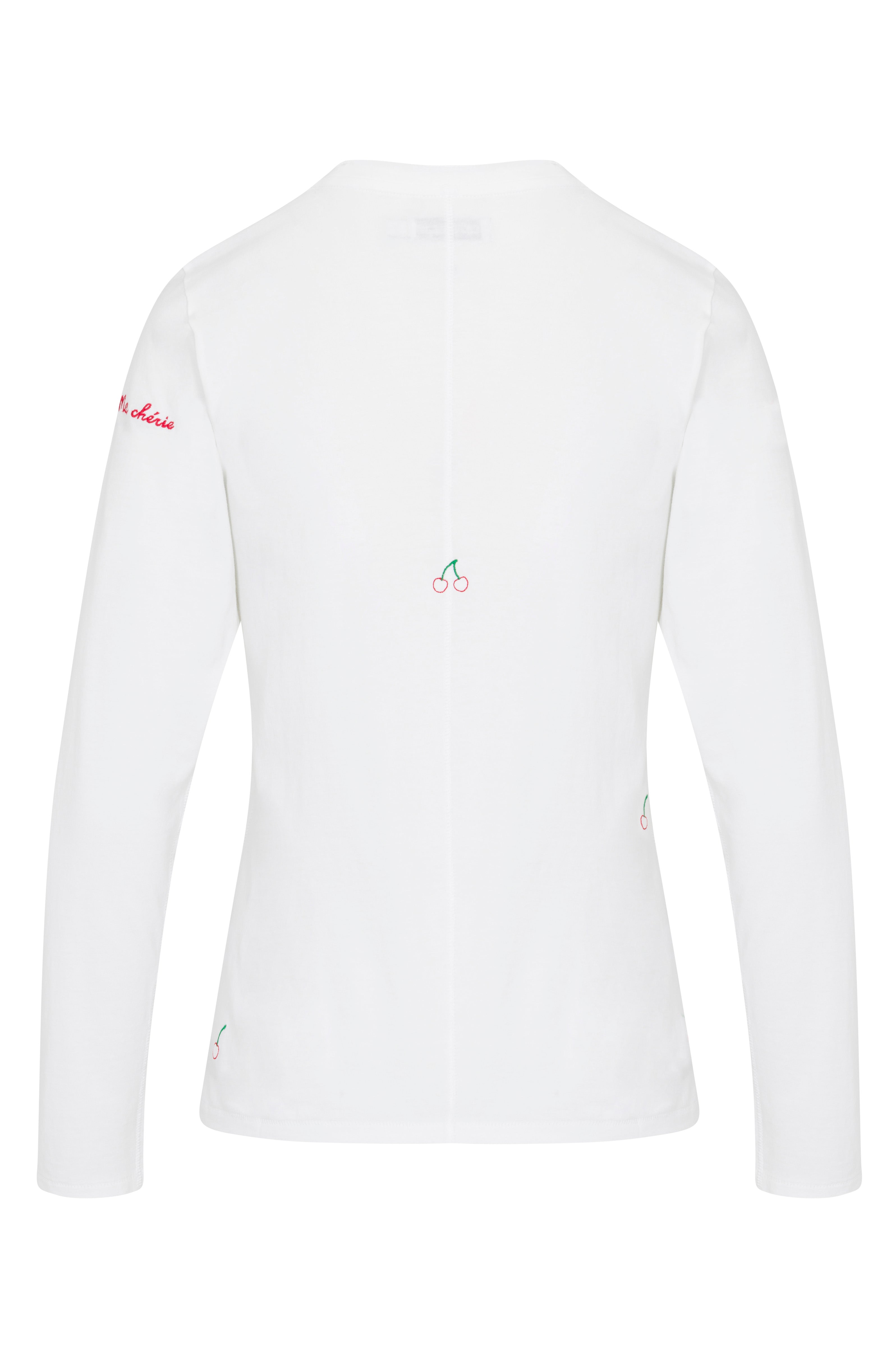 Back-view of a Catherine Gee Embroidered Cotton Long Sleeve Cherry white T-Shirt features small embroidered cherry designs. There is a small cherry embroidery in the center of the back and additional cherry embroidery near the bottom sides and the right sleeve has red text embroidered near the shoulder. The shirt is simple yet stylish, with subtle and charming details.