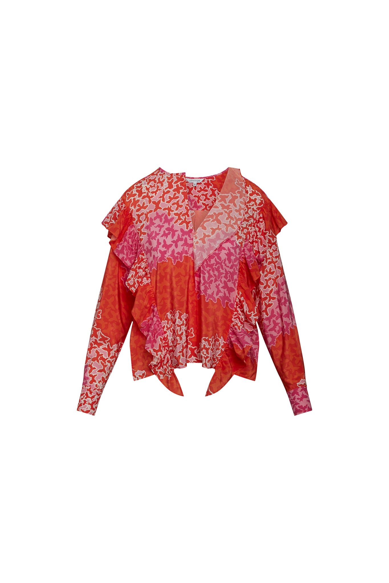 A Catherine Gee Bella - Mariposa blouse features a vibrant mix of red, pink, and orange hues with an abstract butterfly pattern. It has long sleeves, ruffled layers, and a slightly flared hem, creating an elegant and unique design.