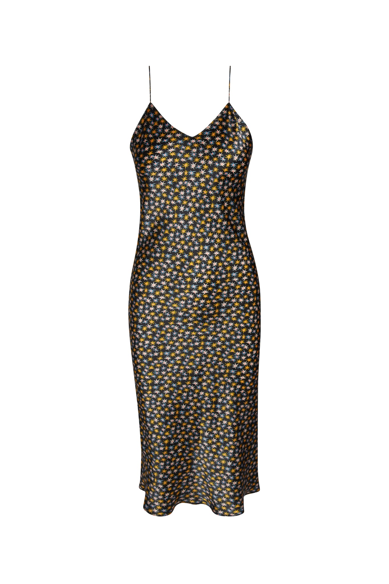 A Celeste cowl back slip dress - star flower by Catherine Gee with thin spaghetti straps featuring a cowl neckline and a fitted silhouette. The dress has a dark background with a small, intricate floral pattern in shades of yellow, white, and blue. The hemline falls below the knee.
