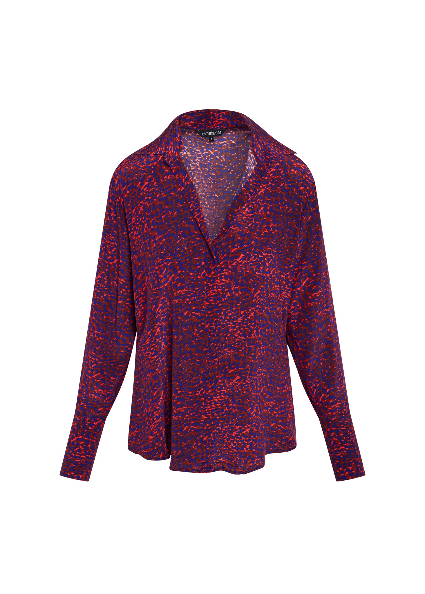 Catherine Gee Daria French Cuff Silk-Milan Print blouse in a vibrant pattern with a mix of red and purple colors. The blouse features a relaxed fit with long sleeves, a deep V-neckline, and a classic collar. The fabric has a silky texture, and the design includes French cuffs for an elegant touch.