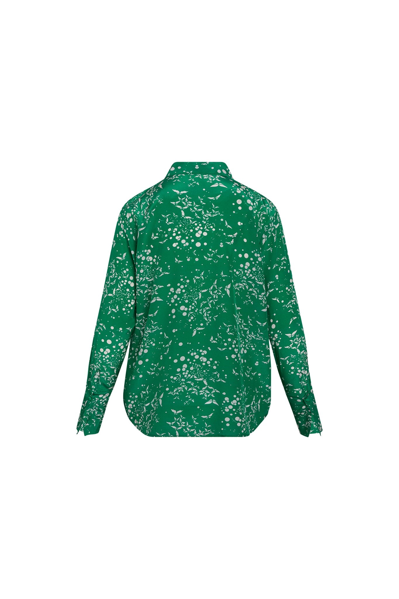 Back-view of a green Catherine Gee Daria French Cuff Silk - Celestial Butterfly blouse features long sleeves with French cuffs and a curved hemline. The pattern consists of white abstract shapes and dots scattered across the fabric, resembling a celestial or butterfly theme.