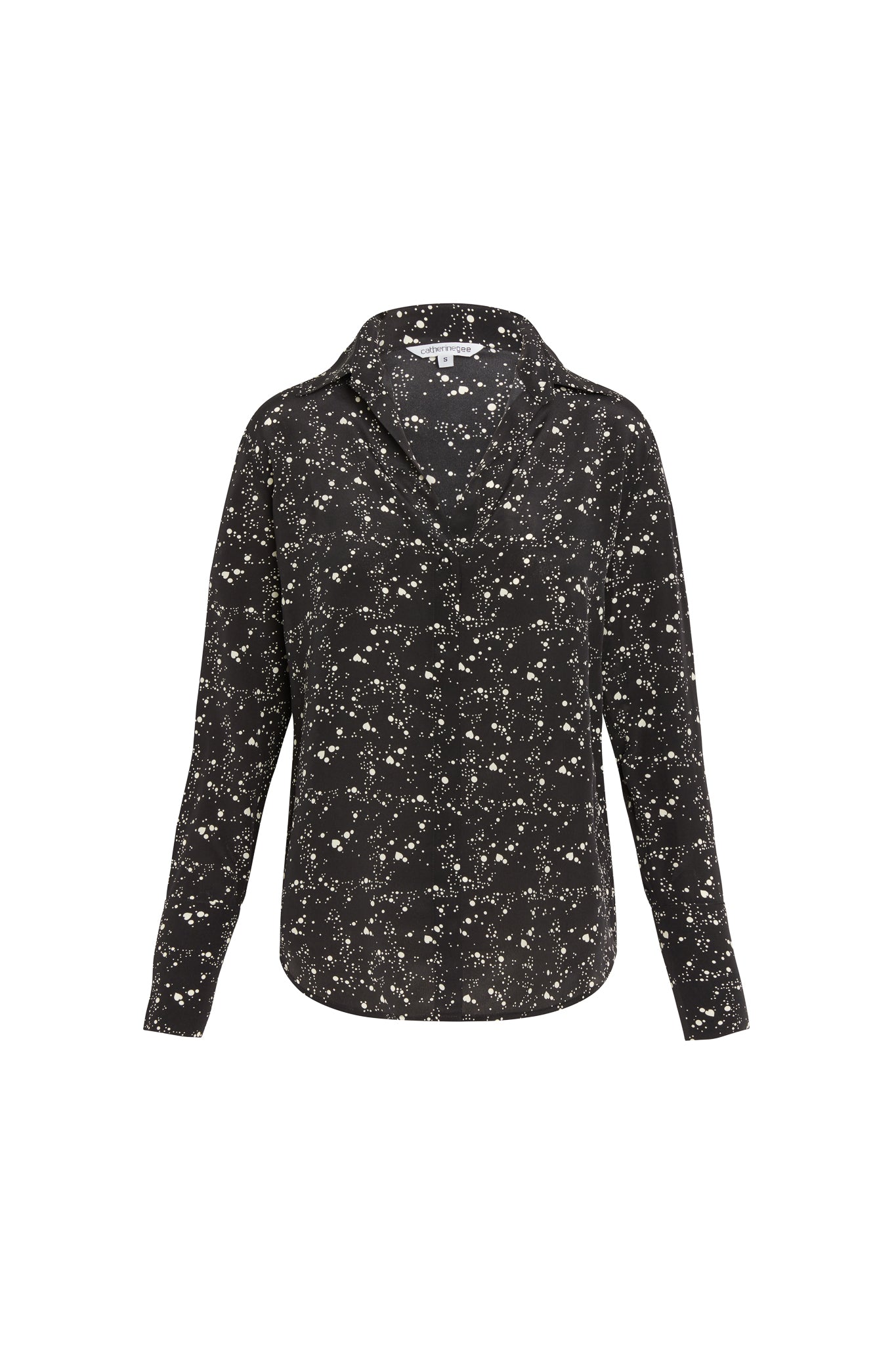 Catherine Gee Daria French Cuff Silk Dot Heart Blouse in black with a white dot heart pattern features a V-neckline, long sleeves with French cuffs, and a relaxed fit.