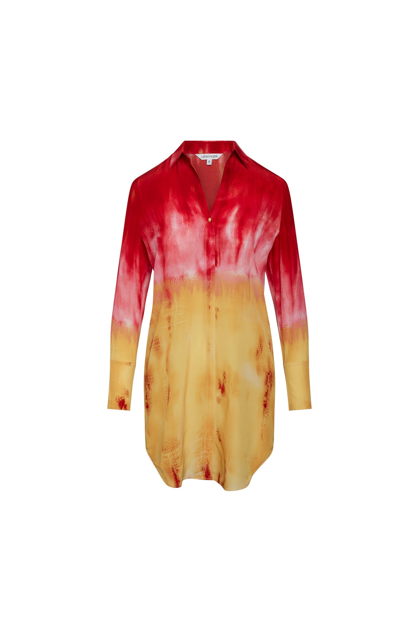 Catherine Gee Daria Silk Shirt Santa Barbara Sunset dress features a stunning gradient color scheme, transitioning from a deep red at the top to a warm yellow at the bottom, reminiscent of a sunset. It has a button-down front, long sleeves, and a collar, offering a sophisticated yet vibrant look. The unique color blend and luxurious silk fabric make this dress a standout piece, perfect for both casual and elegant occasions.
