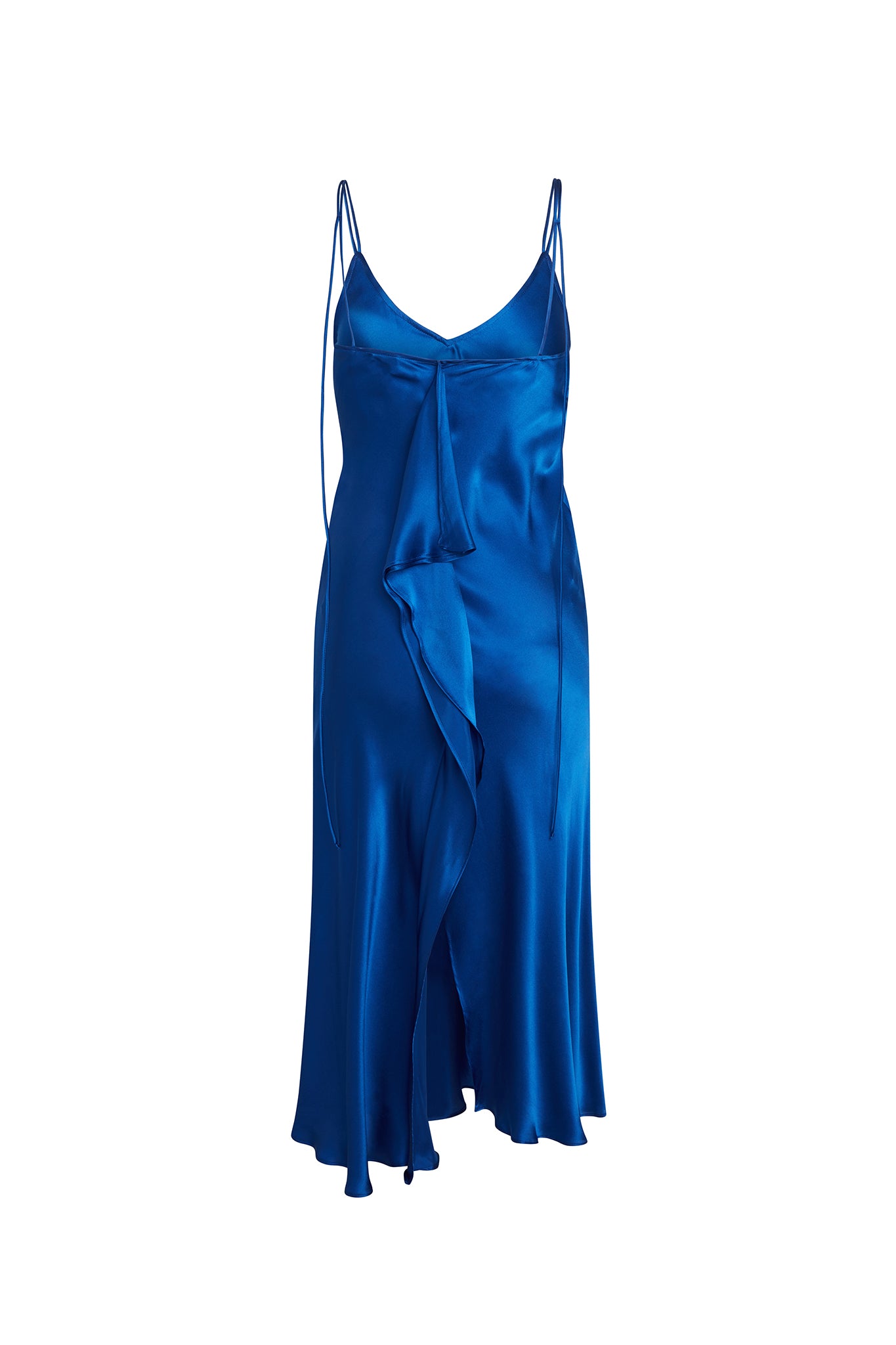 Back-view of Catherine Gee Emma Mykonos Blue Slip dress features a vibrant blue color with a silky, satin finish. It has thin spaghetti straps and a V-neckline, with a cascading ruffle detail down the front. The dress has a midi length, with an asymmetrical hemline that adds a touch of sophistication and movement. The luxurious fabric and striking color make it a standout piece for special occasions.