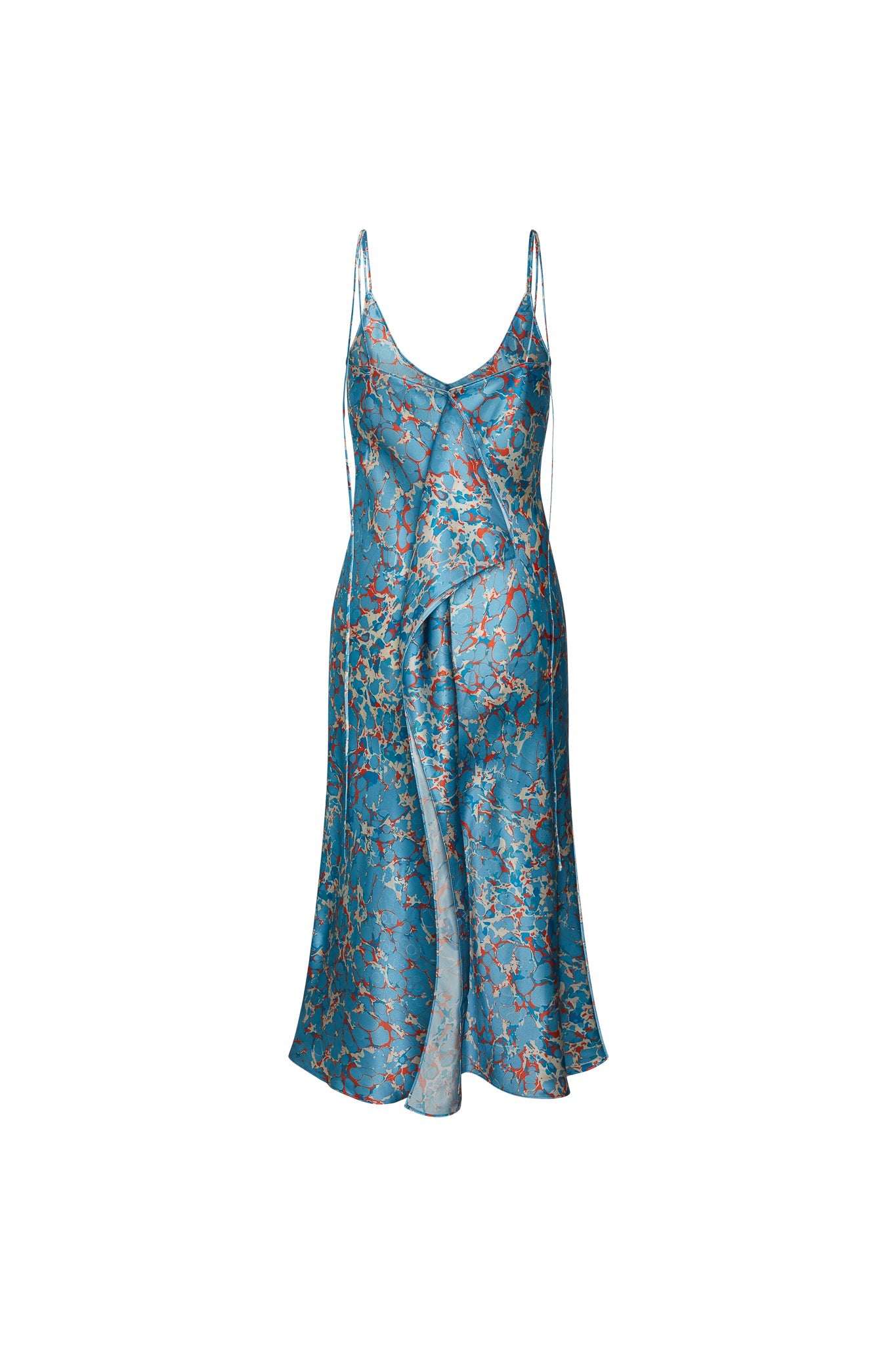 Back-view of Catherine Gee Emma Corfu Slip Dress. This elegant dress features a delicate floral pattern on a blue background. It has a V-neckline with thin spaghetti straps and a flowing, asymmetrical hemline that adds a touch of sophistication. The dress appears to be made of a silky, lightweight fabric, making it suitable for both casual and formal occasions. The intricate design and luxurious material make this dress a standout piece.