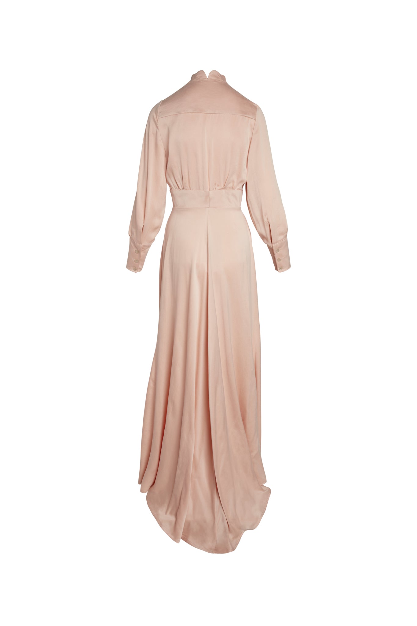 Back-view of a Catherine Gee Electric Flou High-Slit Long Dress. The dress is a soft, Nude color and features long sleeves with cuffs, a high collar, and a fitted waist that accentuates the figure. The skirt of the dress is long and flowing, with a high slit that adds a touch of elegance and sophistication. The fabric appears to be lightweight and drapes beautifully, creating a graceful and refined look.