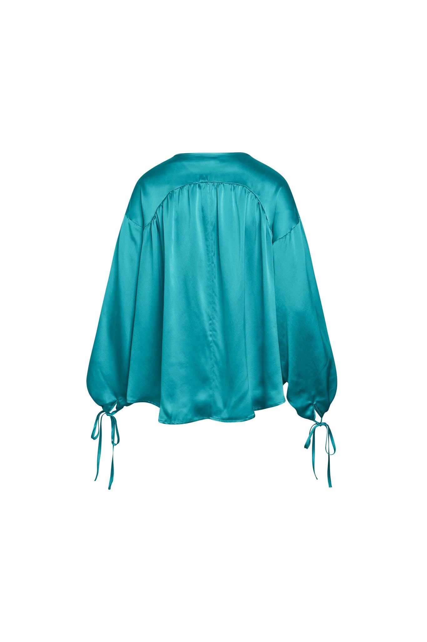 Back-view of a Catherine Gee Frances Van Gogh Green blouse is made of a silky, smooth fabric with a vibrant green color and features a loose, flowing design with long, voluminous sleeves that gather at the wrists and are tied with matching fabric strings. The back has a yoke detail that adds structure to the otherwise relaxed fit. The blouse's luxurious texture and unique design make it a standout piece.