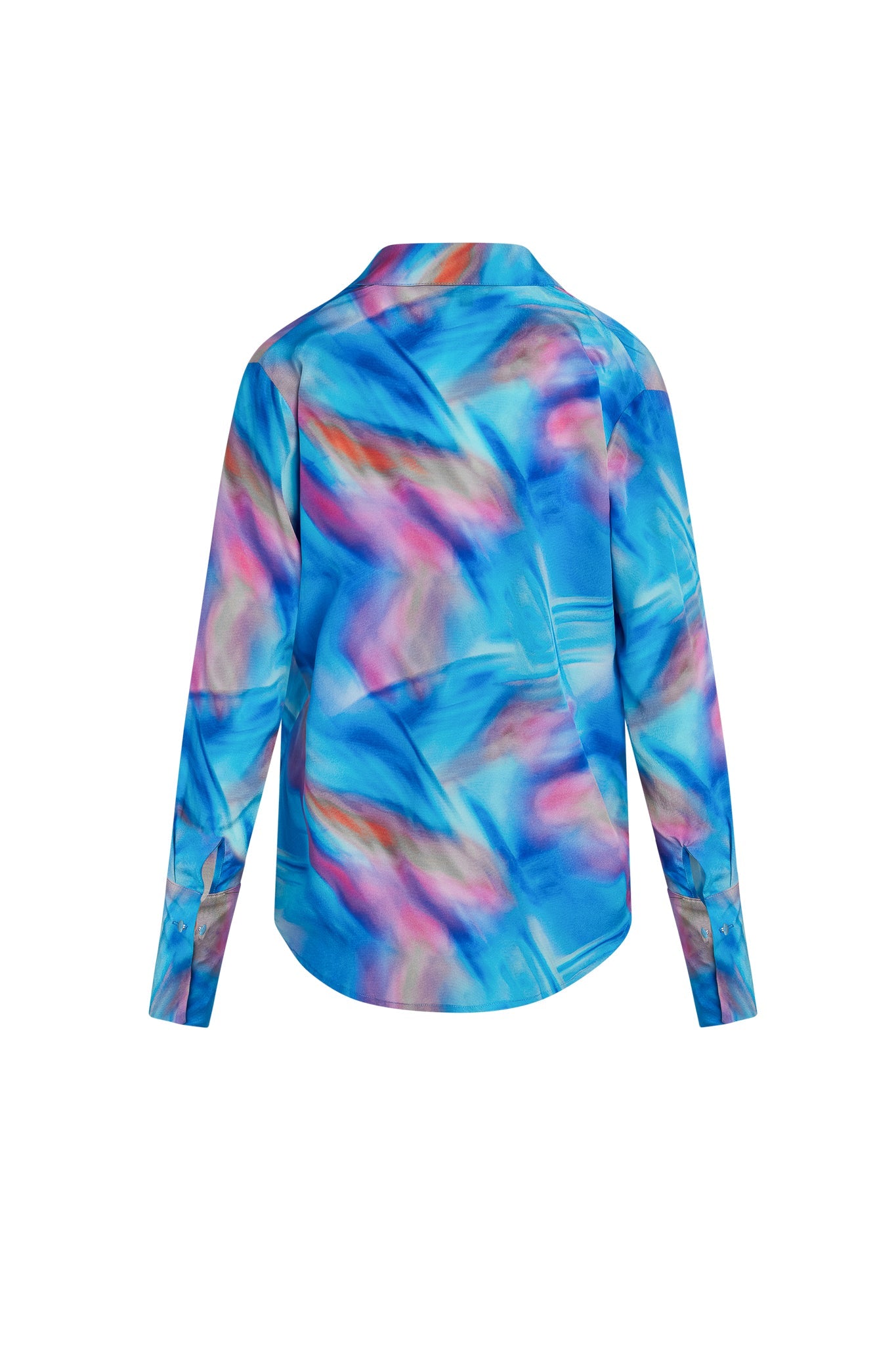 The back view of a Catherine Gee Daria French Cuff Silk Blue Prism blouse features a vibrant abstract design with shades of blue, pink, and purple, long sleeves with French cuffs and a curved hemline.