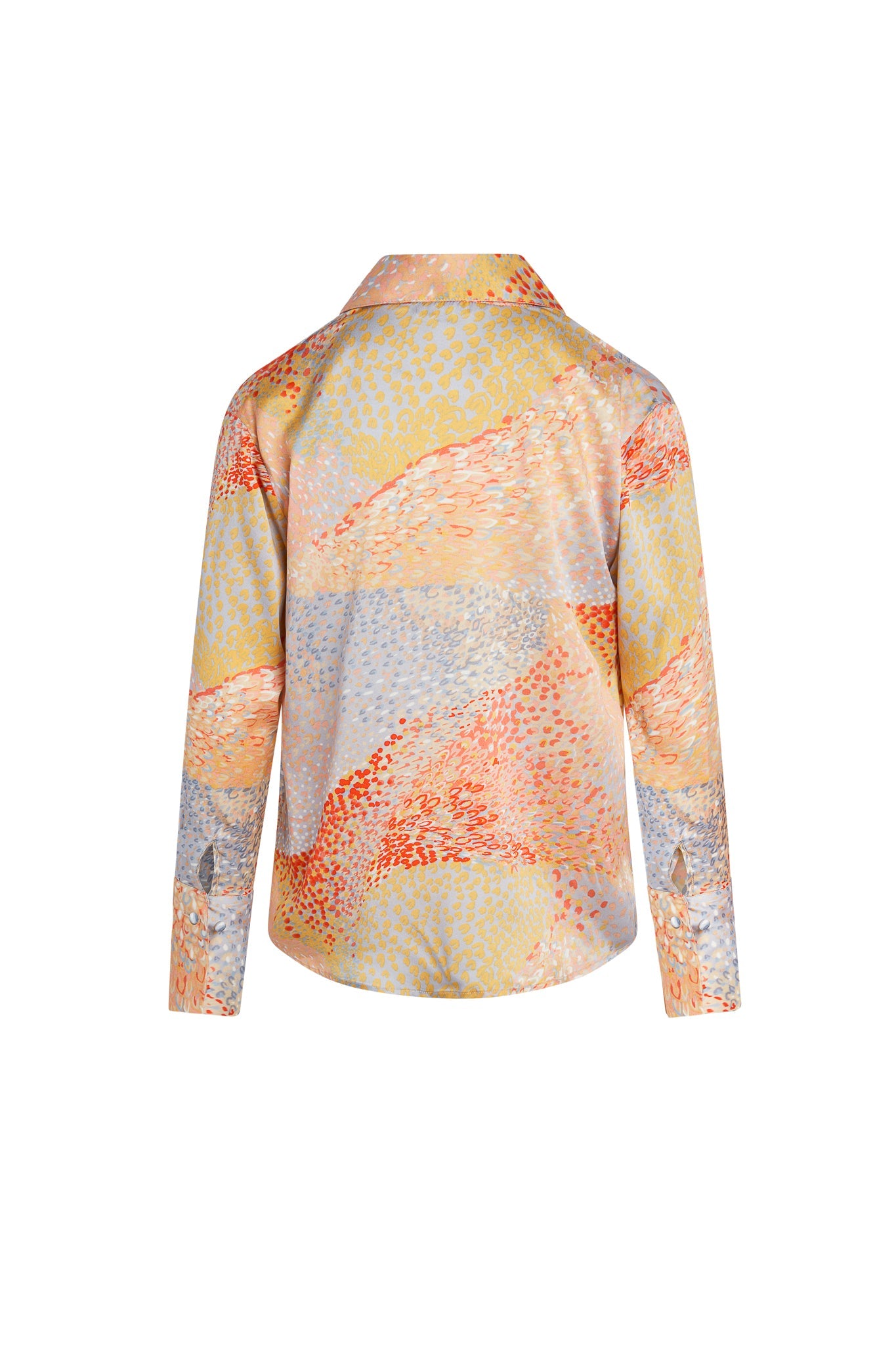 Back-view of a Catherine Gee Daria French Cuff Silk Warm Cosmos blouse features a vibrant and abstract pattern with a mix of warm colors, including shades of orange, yellow, and blue. The design appears to be inspired by cosmic or celestial themes, with a scattered, almost pointillist texture, has long sleeves with French cuffs and a classic collar, giving it a sophisticated and elegant look.