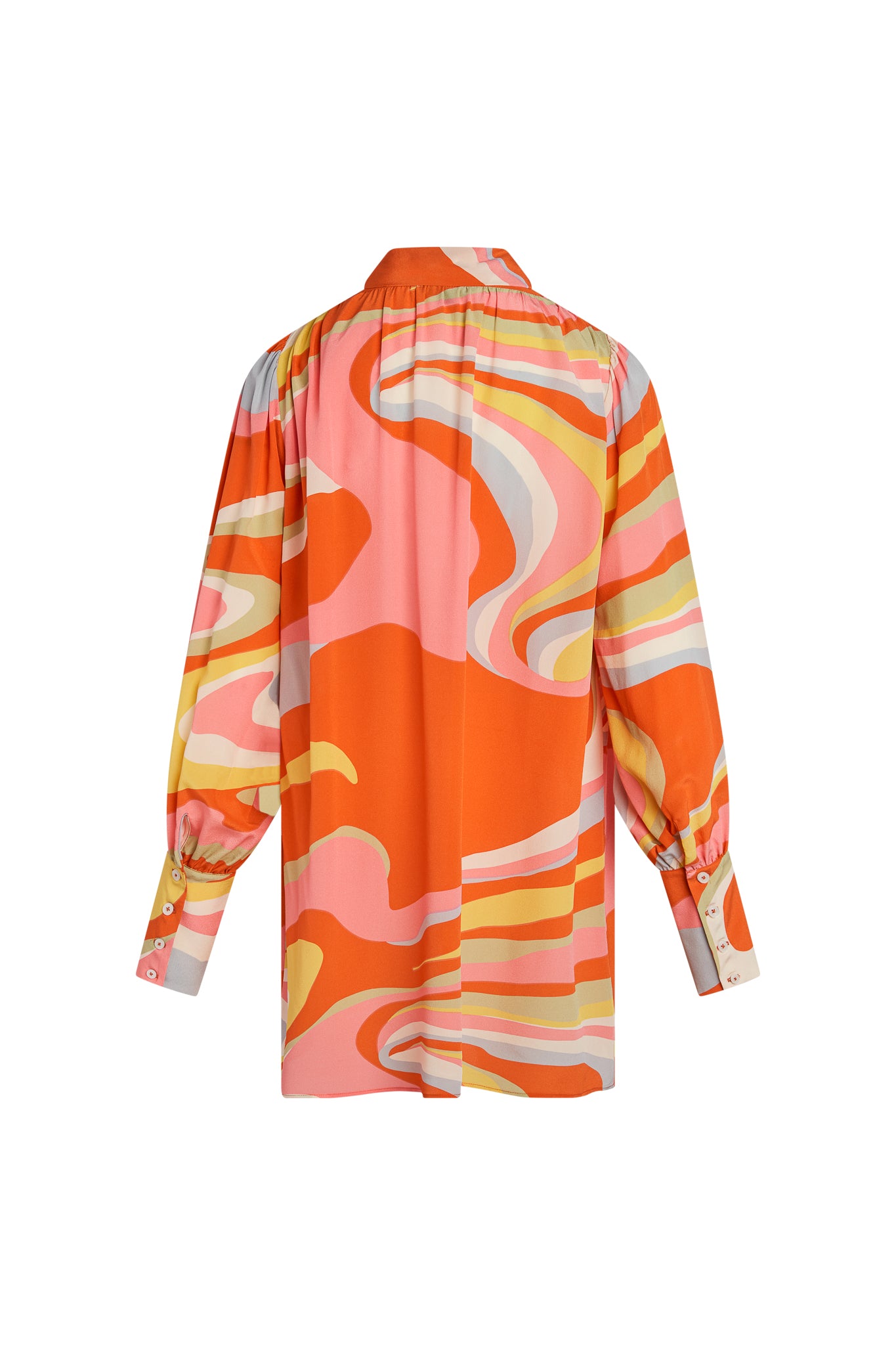 The image shows the back view of a Catherine Gee Aussie Short Dress - Sherbet features a vibrant, abstract swirl design in shades of orange, pink, yellow, and white. It has long sleeves with buttoned cuffs and a gathered detail at the shoulders. The dress has a loose, flowing fit and a collar at the neckline.