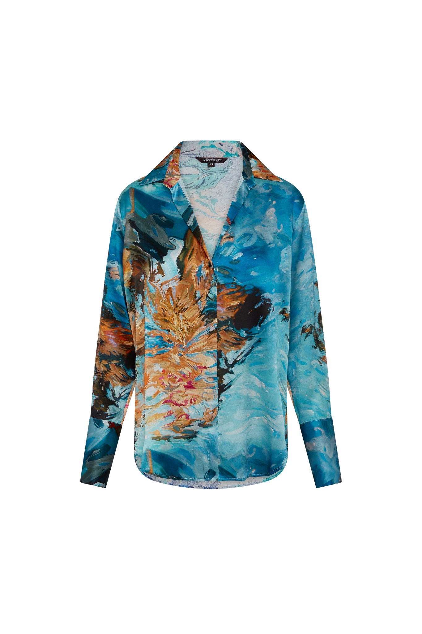 Catherine Gee Daria French Cuff Silk Blouse - 7 Girls featuring a vibrant abstract pattern with shades of blue, brown, black, and orange. The blouse has a classic collar, long sleeves with French cuffs, and a button-down front.