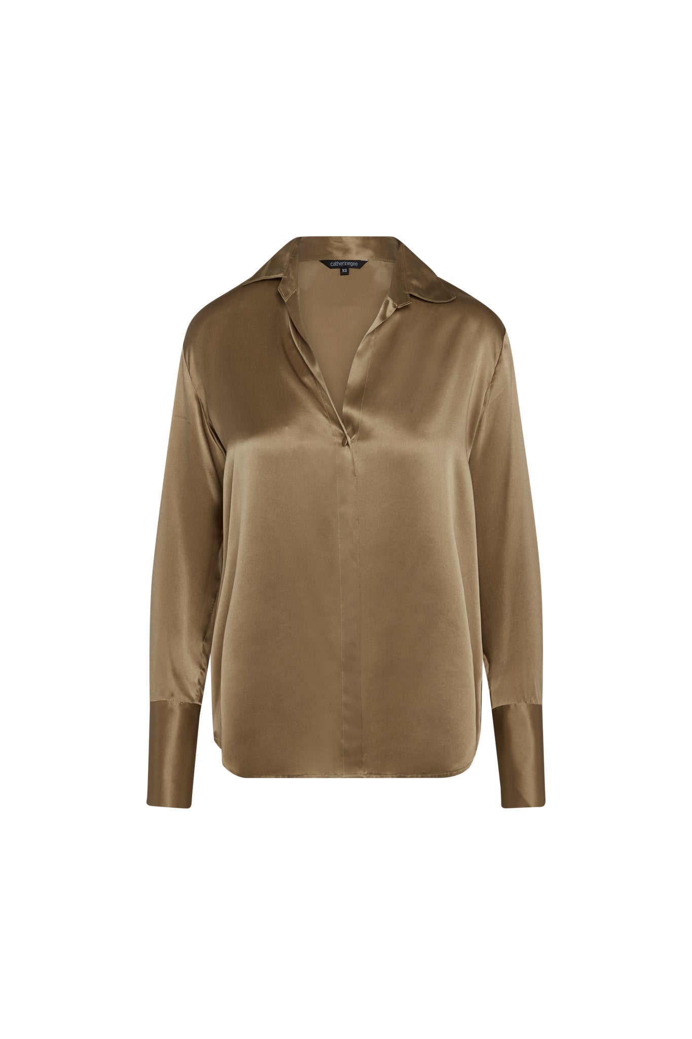 Catherine Gee Daria French Cuff Silk-Mocha blouse features a luxurious silk fabric with a smooth, shiny finish. It has a classic collar, long sleeves with French cuffs, and a relaxed fit. The mocha color adds a rich, warm tone to the elegant design.