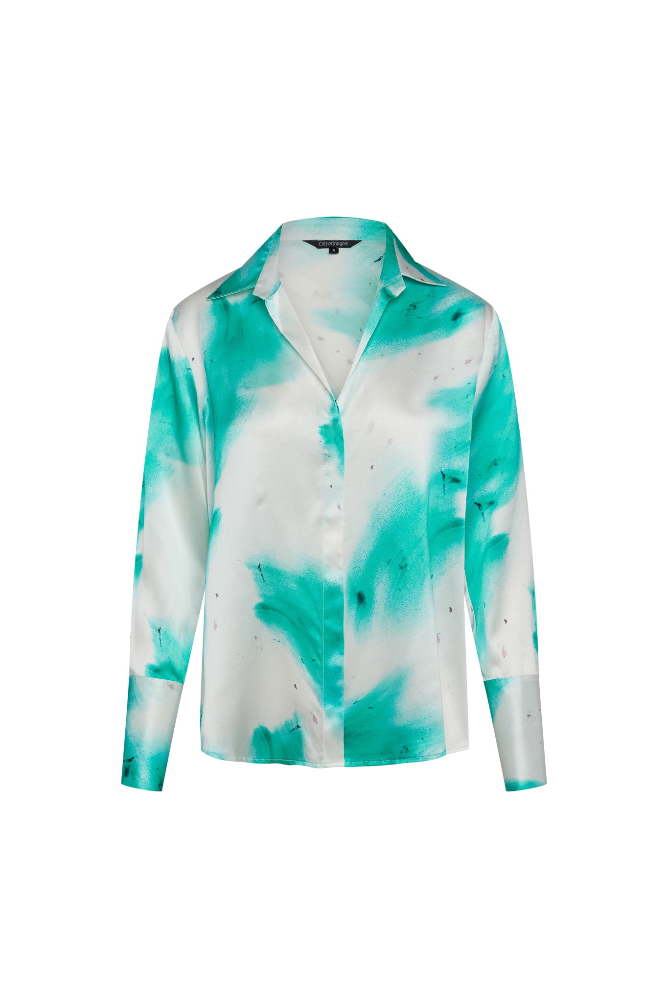 Catherine Gee Daria French Cuff Silk Teal Art blouse features a vibrant teal and white abstract pattern, giving it a unique and artistic appearance. It has a classic collar, long sleeves with French cuffs, and a button-down front. The silk material adds a luxurious feel, making it a stylish and elegant choice for various occasions.