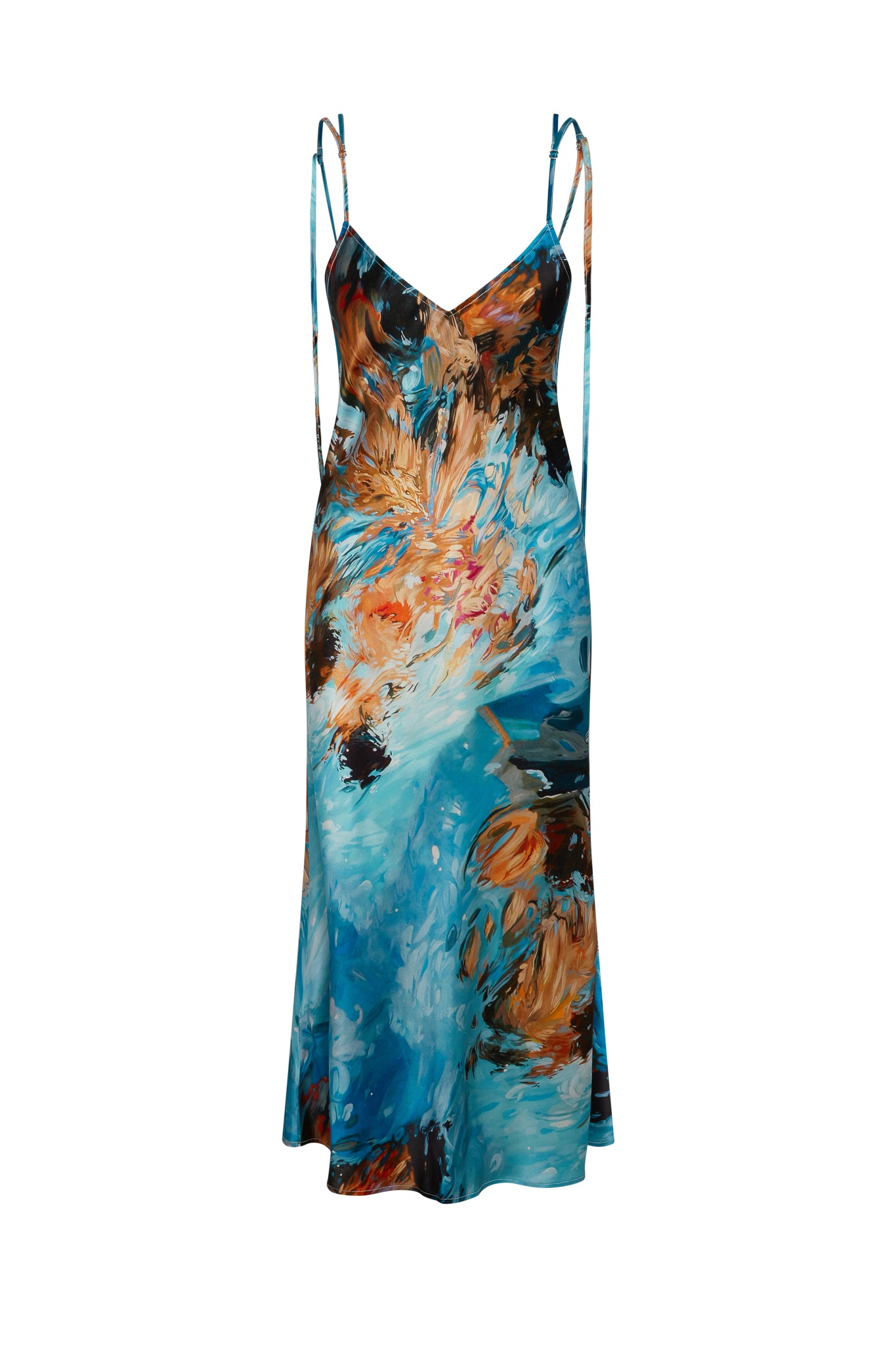 Catherine Gee Emma 7 Girls Slip Dress. This elegant slip dress features a vibrant abstract print with a mix of turquoise, orange, and black hues, creating a dynamic and eye-catching design. The dress has thin spaghetti straps and a V-neckline, giving it a delicate and feminine look. The fabric appears to be lightweight and flowy, making it suitable for warm weather or special occasions.
