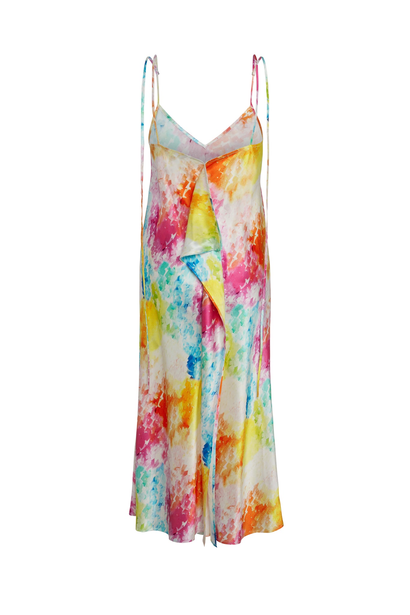 Catherine Gee Emma Rainbow Moodboard Slip Dress. This dress features a vibrant, multicolored tie-dye pattern with shades of red, yellow, orange, pink, blue, and green. It has a V-neckline, thin adjustable spaghetti straps, and a flowing, asymmetrical ruffle detail down the front. Made from a lightweight, silky fabric, giving it a breezy and elegant appearance, perfect for a summer outing or casual event.
