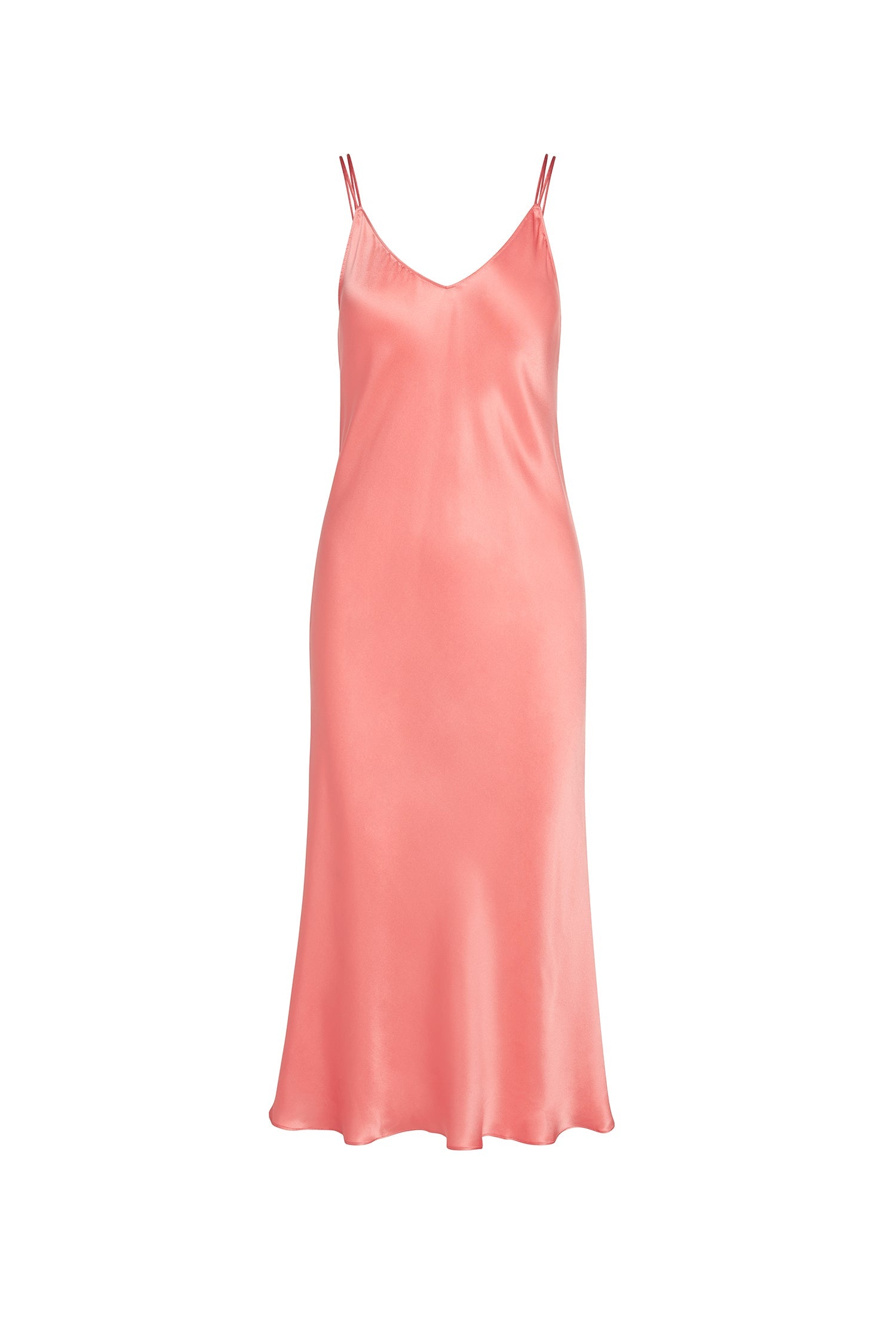 Catherine Gee Emma Salmon Slip elegant dress features a sleek, minimalist design with a V-neckline and thin spaghetti straps. Made from a smooth, satin-like fabric in a salmon pink color, which gives it a luxurious and sophisticated appearance. The dress falls to a midi length, creating a graceful and flowing silhouette that is both timeless and versatile.