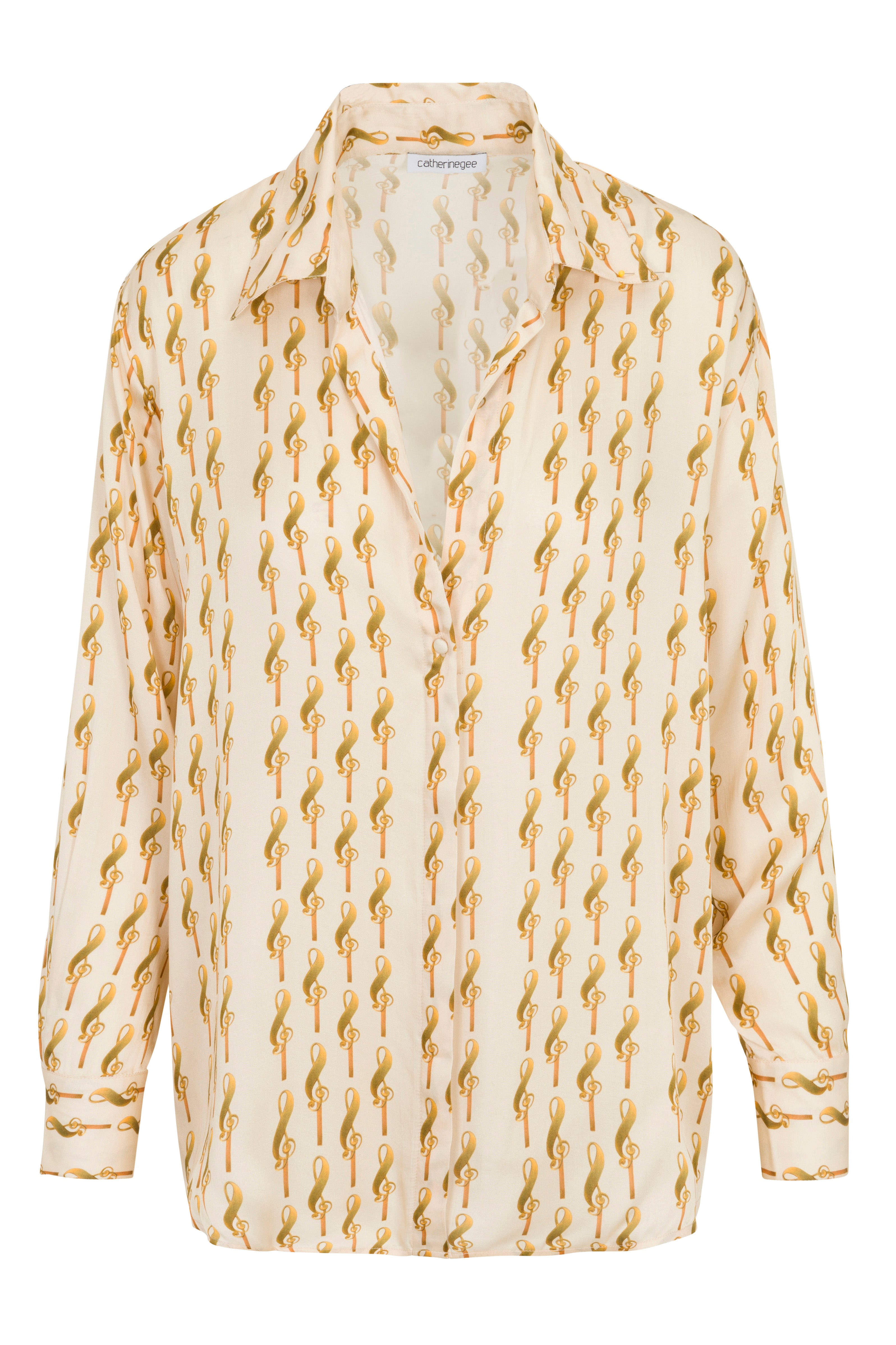 A Catherine Gee Dakota Blouse featuring a pattern of yellow treble clefs on a white background. The blouse has long sleeves, a collar, and a partially undone button-down front.