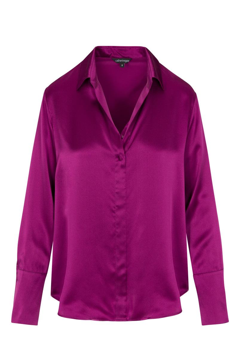 Catherine Gee Daria French Cuff Silk Blouse Fuchsia. A vibrant fuchsia silk blouse with a classic collar and French cuffs features a smooth, shiny texture and a button-down front. The long sleeves and elegant design make it suitable for both professional and casual settings.