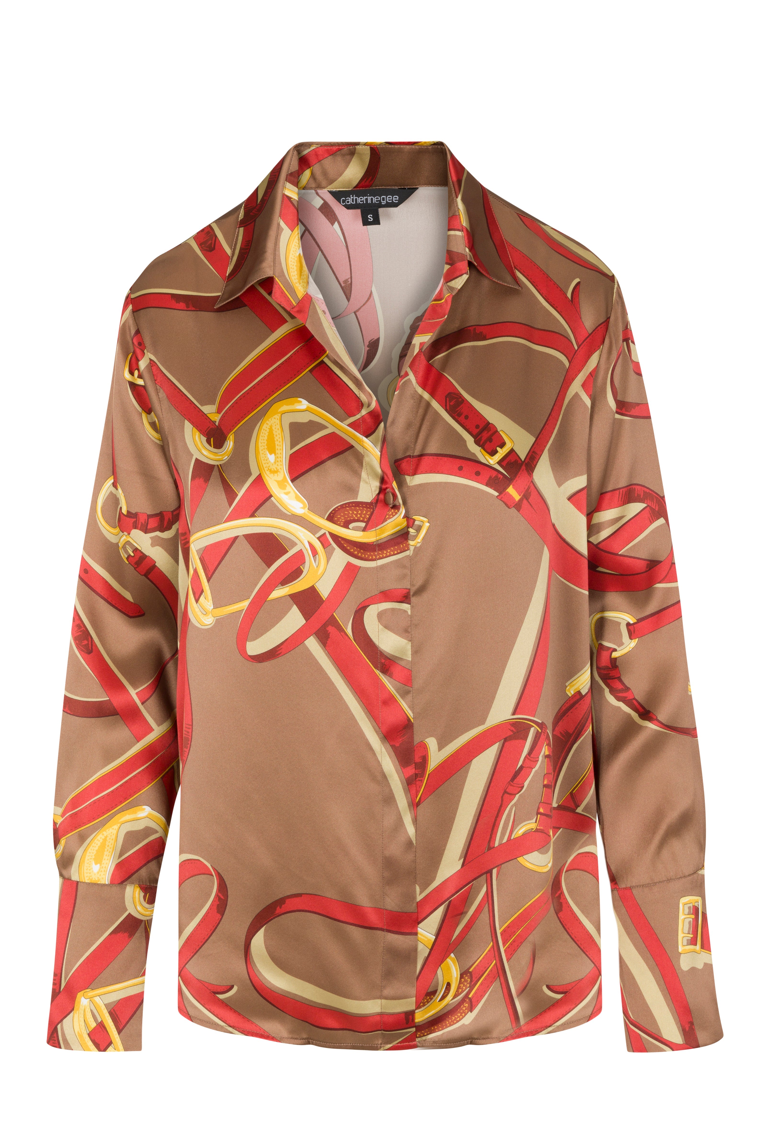 Catherine Gee Daria French Cuff Silk-Lexington Equestrian blouse features a brown base with an intricate pattern of red and gold equestrian-themed ribbons and straps. It has a classic collar, long sleeves, and French cuffs.