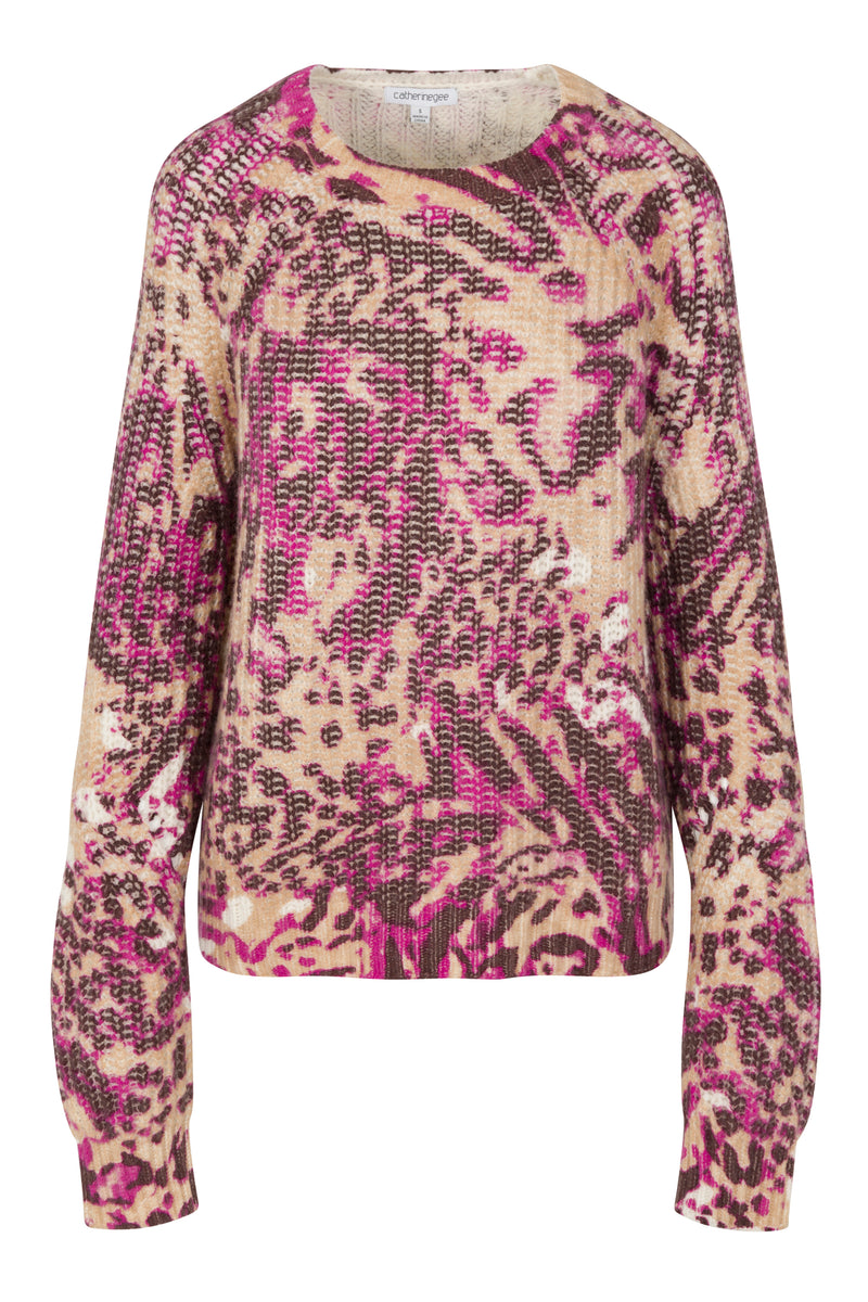 Catherine Gee Isabela Chunky Cashmere Fuchsia Feline sweater features a vibrant and intricate pattern with shades of fuchsia, brown, and beige, resembling a mix of animal prints. Made of soft, chunky cashmere, it provides both warmth and style. The long sleeves and relaxed fit add to its cozy and fashionable appeal, making it a standout piece in any wardrobe.