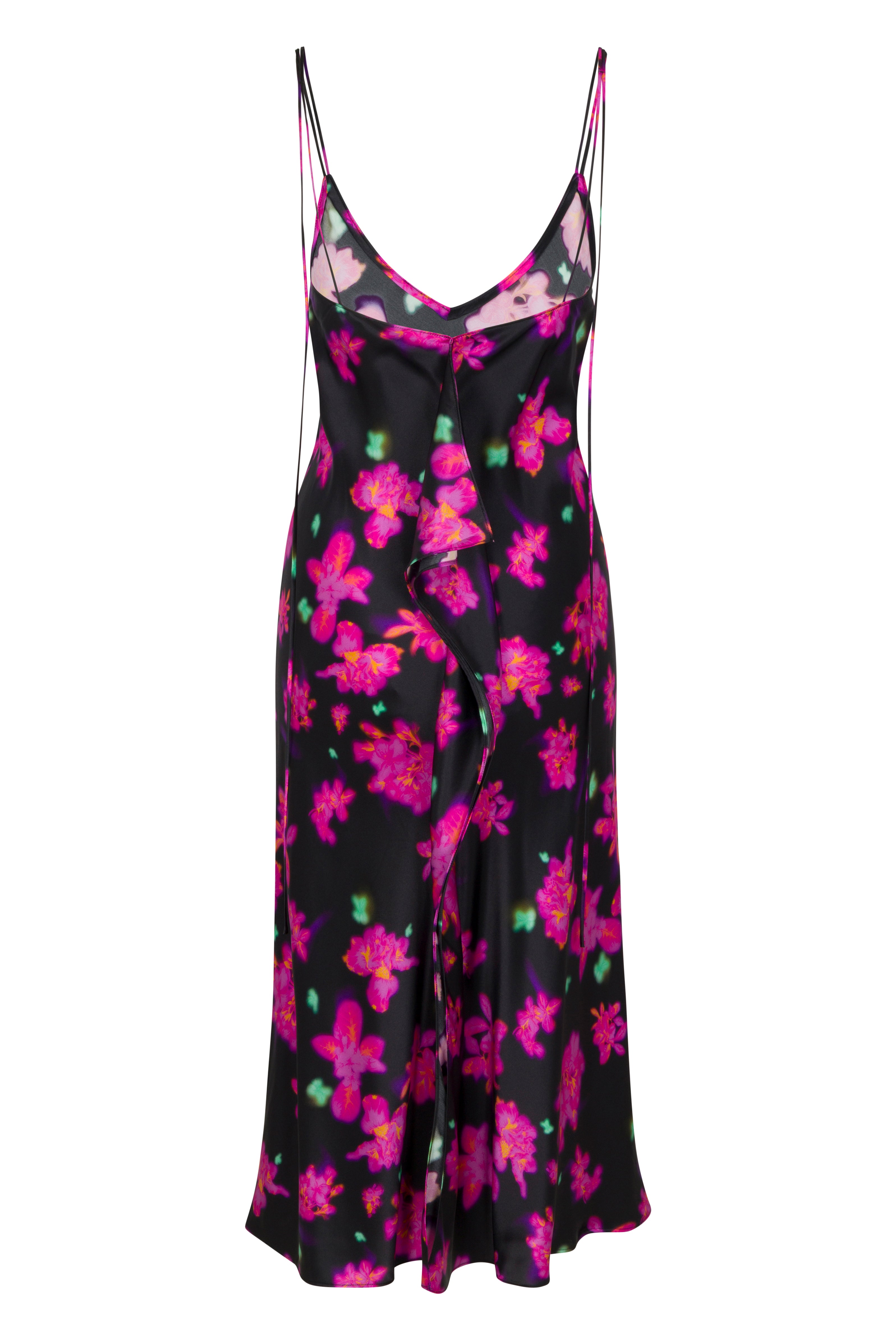 Back-view of Catherine Gee Emma Neon Flower Slip Dress. This dress features a vibrant neon floral pattern on a black background. It has a V-neckline with thin spaghetti straps and a ruffled detail running down the front. The dress is made of a silky fabric, giving it a smooth and elegant appearance. The bright pink and green flowers stand out against the dark fabric, making it a striking and eye-catching piece.