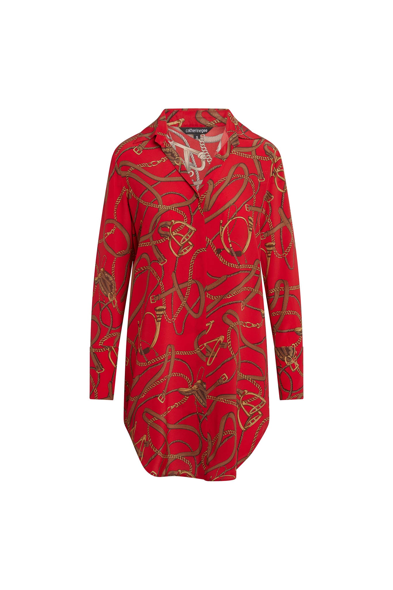 Catherine Gee Daria Silk Shirt Palermo dress is a vibrant red with complex gold chain and rope patterns features a collared neckline, long sleeves, and a loose, flowing fit that falls to mid-thigh. Made from luxurious silk, the dress offers a smooth, elegant appearance, making it a standout piece for both casual and formal occasions.