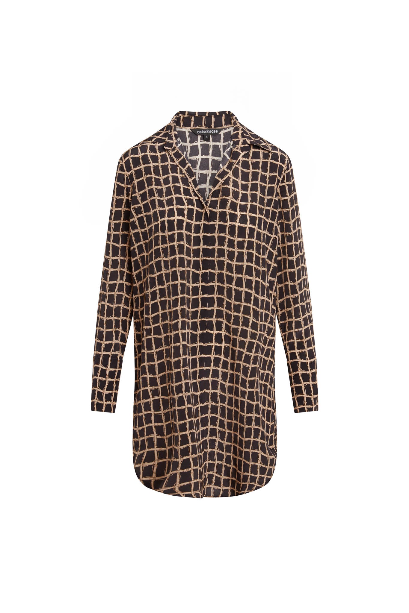 Catherine Gee Daria Recoleta Dress. This elegant dress features a long-sleeve design with a relaxed fit and a button-down front. It has a black base with a beige grid pattern, giving it a modern and stylish look, and includes a collar and a slightly curved hemline, making it versatile for both casual and semi-formal occasions. The lightweight, flowy fabric adds an effortless touch of elegance and sophistication.