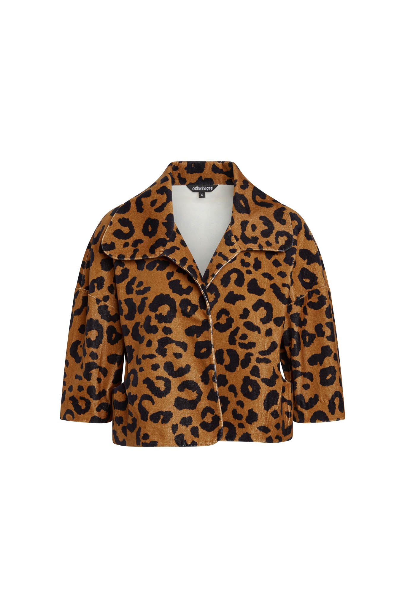 Catherine Gee Alexa Cropped Jacket in a cheetah print pattern features a wide collar, three-quarter-length sleeves, and a button closure. The fabric has a brown base with black cheetah spots, giving it a bold and stylish appearance.