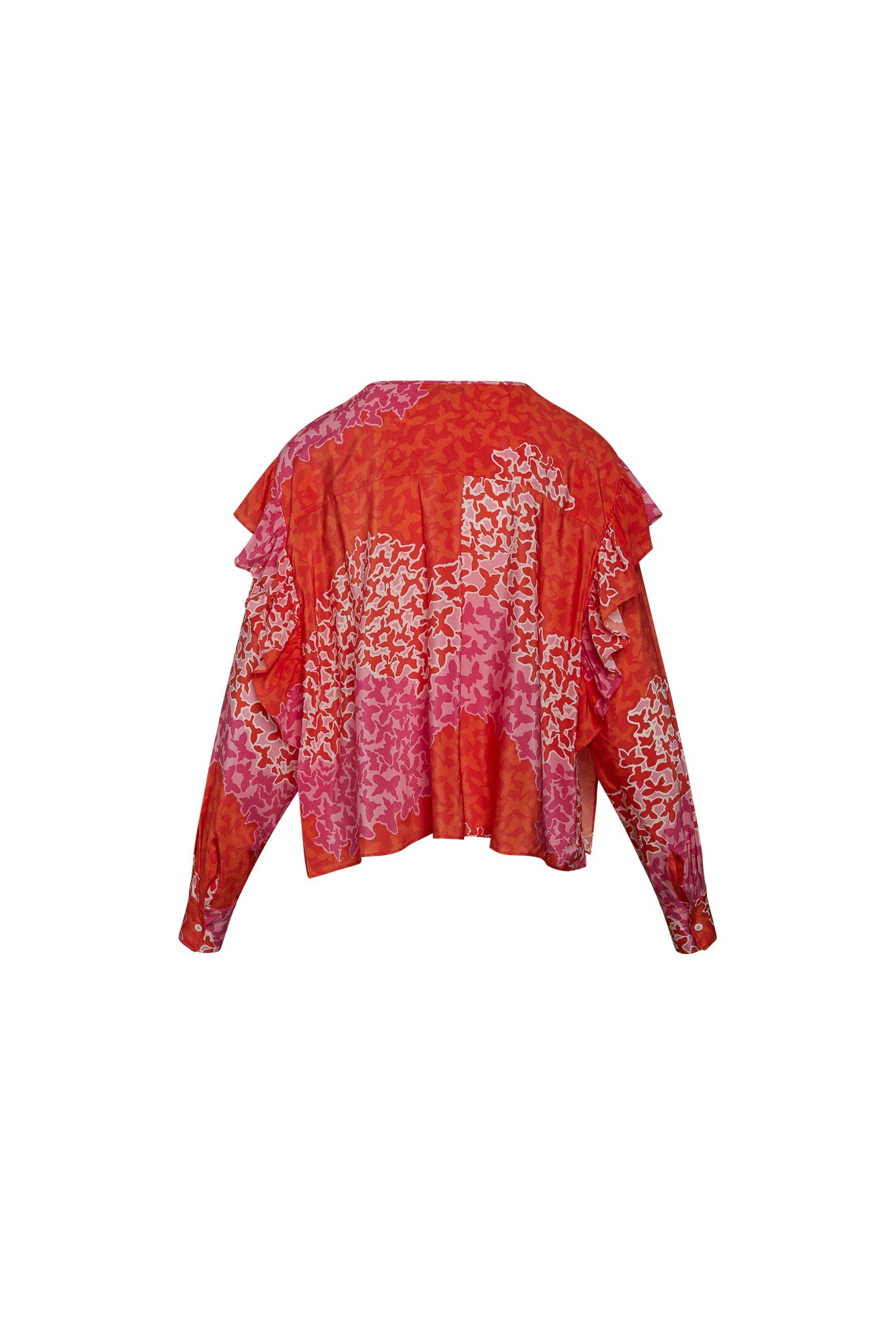 Back view of Catherine Gee Bella - Mariposa blouse features a vibrant mix of red, pink, and orange hues with an abstract butterfly pattern. It has long sleeves, ruffled layers, and a slightly flared hem.