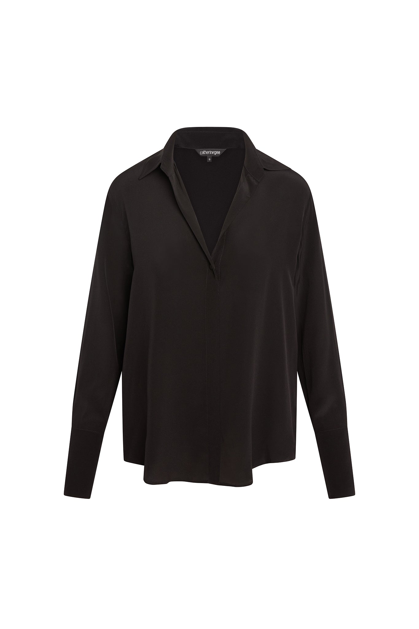 Catherine Gee Daria French Cuff Silk Black Blouse with long sleeves and a French cuff design, features a classic collar and a concealed button placket, giving it a sleek and elegant appearance. The fabric has a smooth and slightly shiny finish, indicative of high-quality silk.