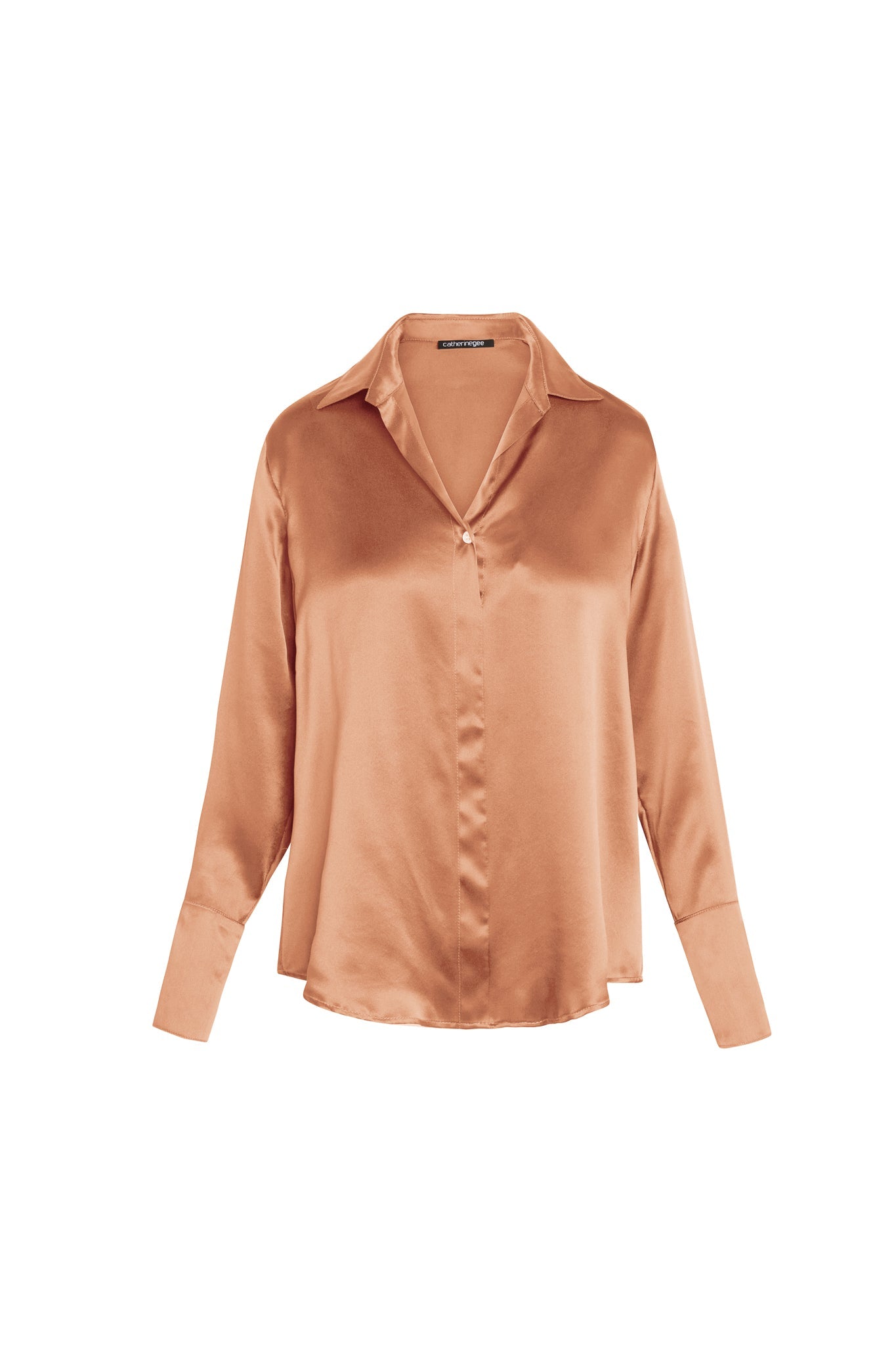A bronze-colored silk blouse with a classic collar and Daria French Cuff, designed by Catherine Gee. The blouse has a smooth, shiny texture and a relaxed fit, with a single button closure at the front. The long sleeves end in wide cuffs, adding a touch of elegance to the overall design.