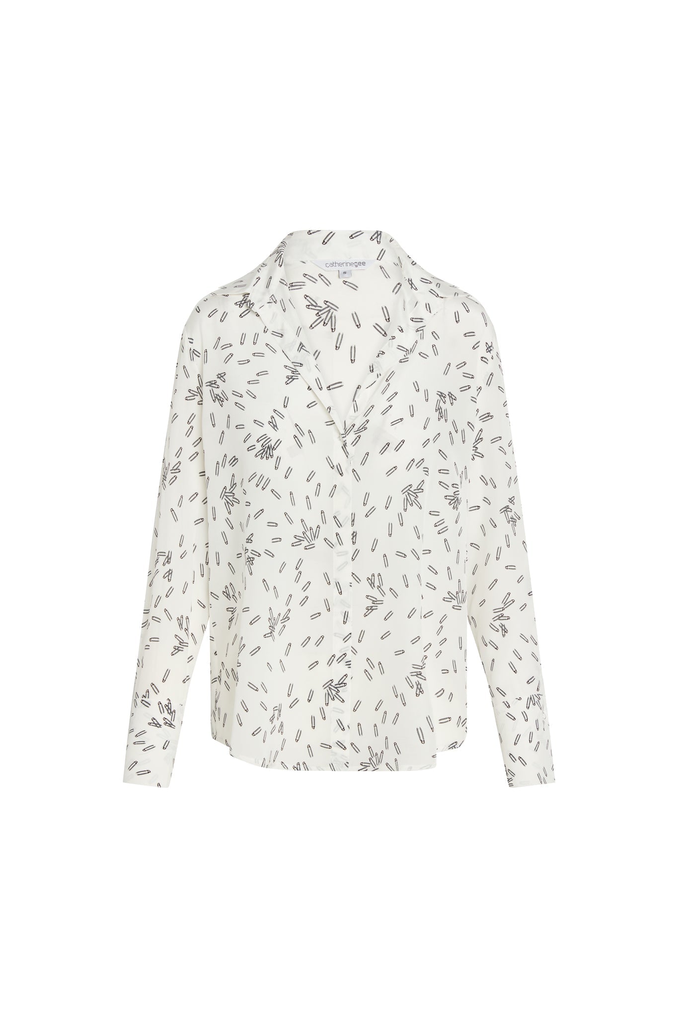 Catherine Gee Daria French Cuff Silk Pin blouse is made of silk and features a white base color with a scattered black pin pattern throughout. It has a classic collar and long sleeves with French cuffs, a relaxed fit, and a button-down front. The design is elegant and versatile, suitable for both professional and casual settings.