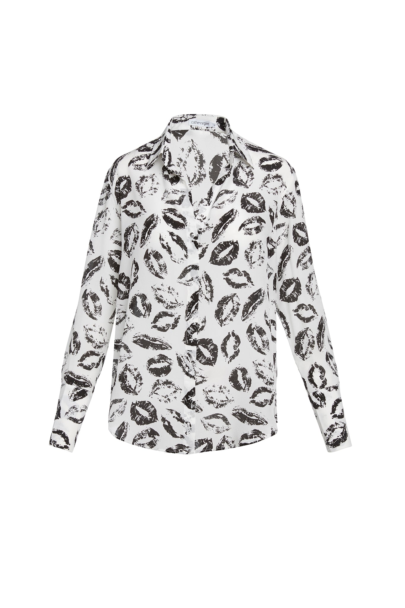 Catherine Gee Daria French Cuff Silk Black and White Lip Print Blouse. A white silk blouse with a black lip print pattern, featuring a classic collar and French cuffs.