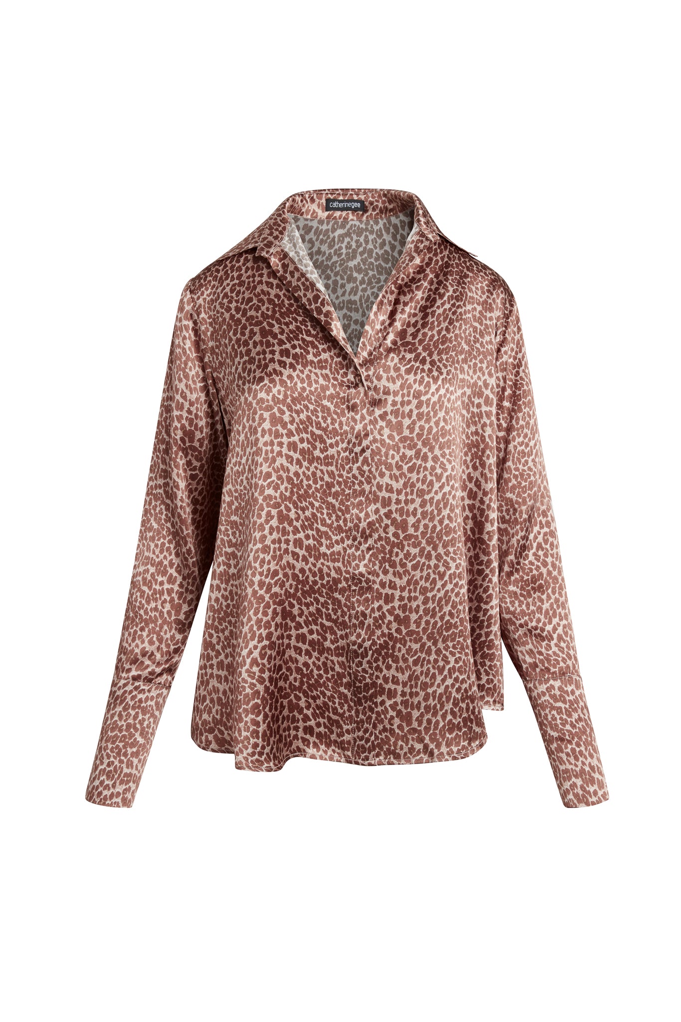 Catherine Gee Daria French Cuff Silk-Electric Leopard blouse features a relaxed fit with a classic collar, long sleeves, and a button-down front. The fabric has a silky sheen with a leopard print pattern in shades of brown and beige.