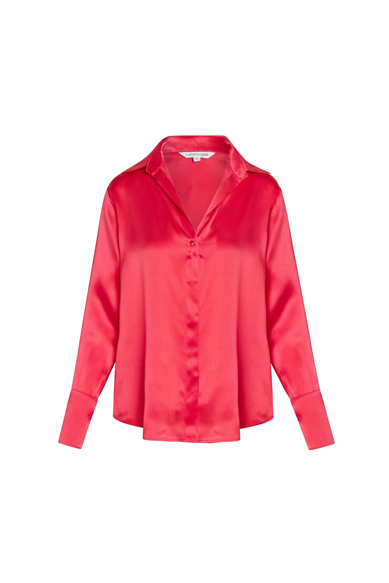 Catherine Gee Daria French Cuff Silk-Electric Pink Blouse features a vibrant pink color with a silky sheen, a classic collar, a deep V-neckline, and long sleeves with French cuffs. The fabric appears smooth and luxurious, giving it an elegant and sophisticated look.