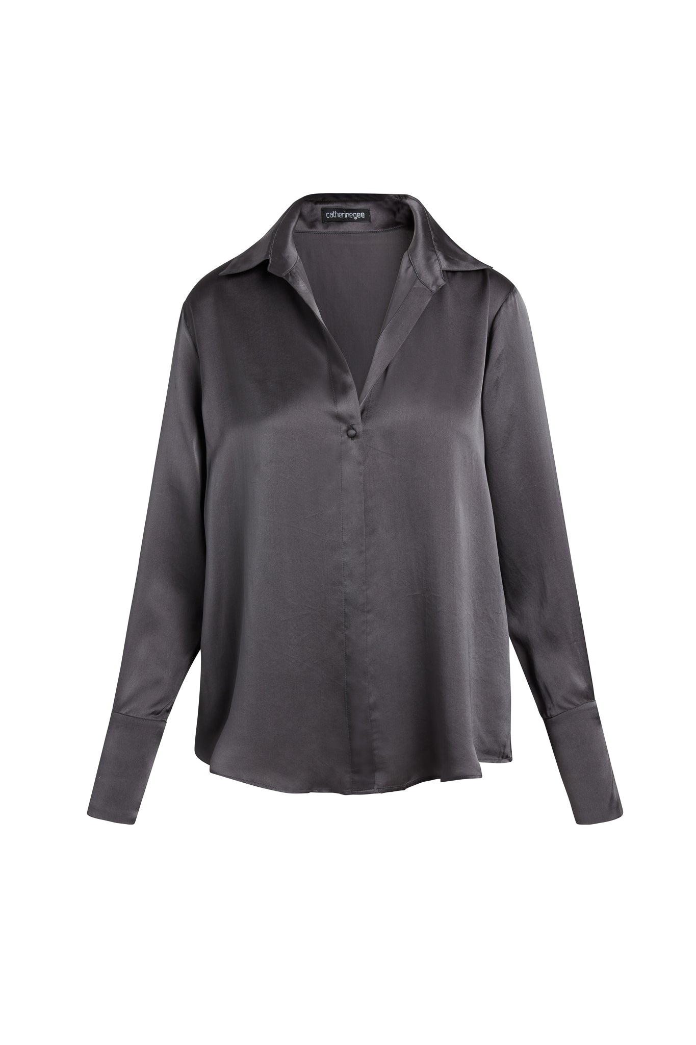 Catherine Gee Daria French Cuff Silk Pewter blouse is made of silk and features a dark gray pewter color with a subtle shine. It has a classic collar and a single-button closure at the front, long sleeves end in elegant French cuffs. The silky texture adds a luxurious touch to the blouse, making it perfect for both formal and casual occasions.
