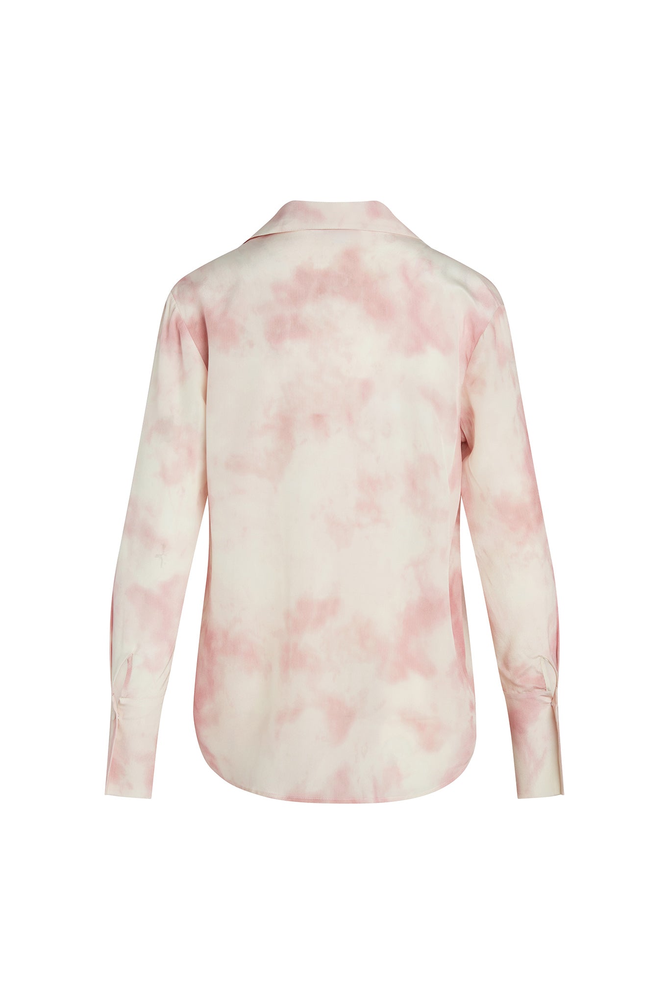 Back-view of a Catherine Gee Daria French Cuff Silk Pink Dye blouse features a soft, pastel pink tie-dye pattern on a white background. It has long sleeves with French cuffs and a curved hemline. The fabric appears to be smooth and silky, indicating high-quality silk material, and has a classic collar and a relaxed fit, making it both elegant and comfortable.