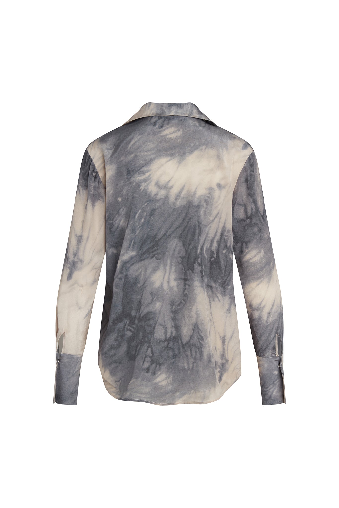 Back-view of a Catherine Gee Daria French Cuff Silk Smoke blouse features a tie-dye pattern in shades of gray and white, creating a smoky effect. It has long sleeves with French cuffs and a classic collar. The fabric appears to be lightweight and silky, giving it a luxurious and elegant look. The unique pattern and high-quality material make this blouse both stylish and sophisticated.